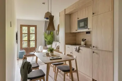 a kitchen and dining room with a table and chairs at Líbere Barcelona Sant Antoni in Barcelona
