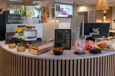 a bakery counter with food on top of it at Hotel SERHS Del Port in Barcelona