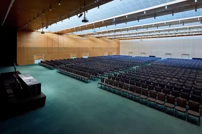 an empty auditorium with blue seats in a building at Hyatt Regency Barcelona Tower in Hospitalet de Llobregat