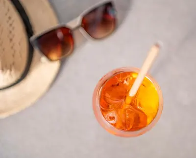 a close up of a drink with a pair of sunglasses at Hyatt Regency Barcelona Tower in Hospitalet de Llobregat