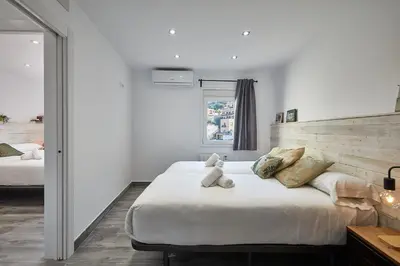 a bedroom with a bed with a teddy bear on it at BBarcelona El Carmel Apartment with terrace in Barcelona