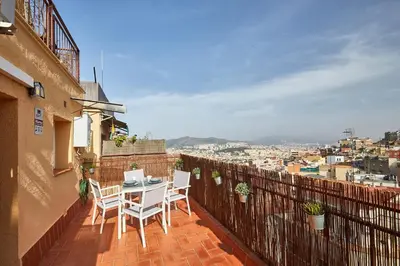 a patio with a table and chairs on a balcony at BBarcelona El Carmel Apartment with terrace in Barcelona