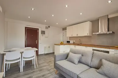 a kitchen and living room with a couch and a table at BBarcelona El Carmel Apartment with terrace in Barcelona