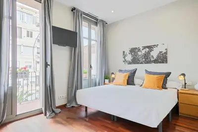 a bedroom with a bed and a large window at My Space Barcelona - Newly renovated apartment in Gràcia for families and executives in Barcelona