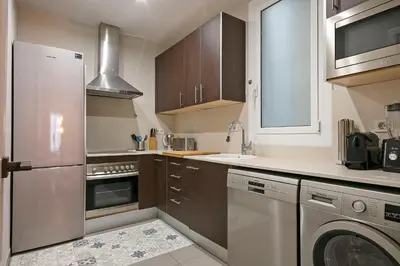 a kitchen with a stainless steel refrigerator and a dishwasher at My Space Barcelona - Newly renovated apartment in Gràcia for families and executives in Barcelona