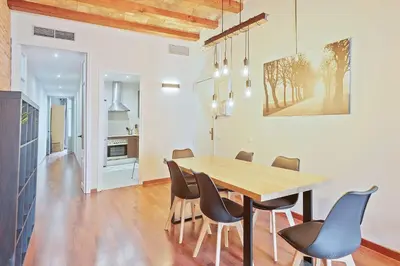 a dining room with a wooden table and chairs at My Space Barcelona - Newly renovated apartment in Gràcia for families and executives in Barcelona