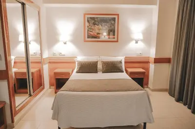 a bedroom with a large bed with two night stands at htop Pineda Palace 4Sup - Adults Only #htopBliss in Pineda de Mar