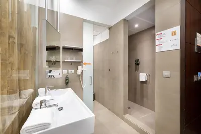 a bathroom with a sink and a shower at Alexandre Fira Congress in Hospitalet de Llobregat