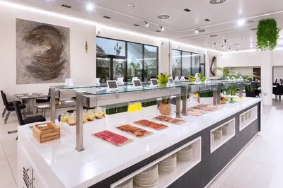 a restaurant with a buffet of food on display at Alexandre Fira Congress in Hospitalet de Llobregat