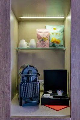 a cabinet with a microwave and a stove in it at Hotel America Barcelona in Barcelona