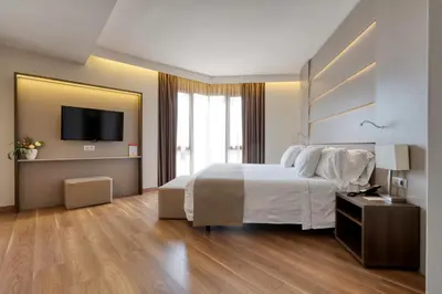 a hotel room with a large bed and a television at Hotel America Barcelona in Barcelona