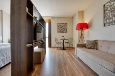 a living room with a couch and a table at Hotel America Barcelona in Barcelona