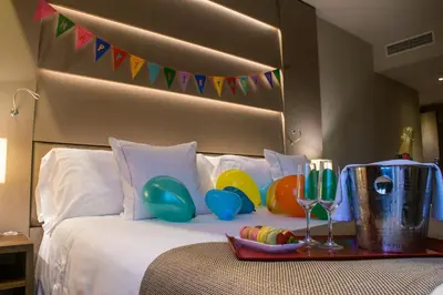 a bedroom with a bed with balloons on it at Hotel America Barcelona in Barcelona