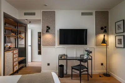 a bedroom with a desk and a tv on the wall at Hotel Barcelona Catedral 4 Sup in Barcelona