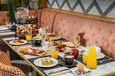 a table with plates of food and glasses of orange juice at Hotel Barcelona Catedral 4 Sup in Barcelona