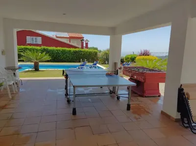 a ping pong table in the middle of a patio at VILLA VALENTINA in Mataró