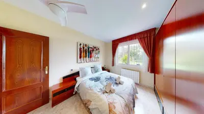a bedroom with a bed and a large window at VILLA VALENTINA in Mataró