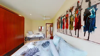 a bedroom with a bed and some paintings on the wall at VILLA VALENTINA in Mataró