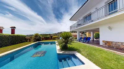 a swimming pool in the backyard of a house at VILLA VALENTINA in Mataró