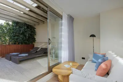 a living room with a white couch and a table at Sercotel Kalma Sitges in Sitges
