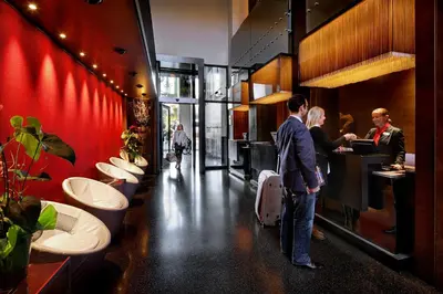 a group of people standing in a bathroom with sinks at Olivia Plaza Hotel in Barcelona