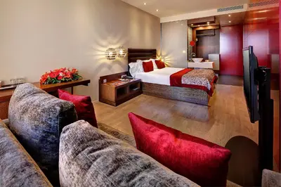 a hotel room with a bed and a couch at Olivia Plaza Hotel in Barcelona