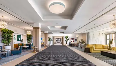 a lobby of a hotel with a large rug at Eurostars Sitges in Sitges