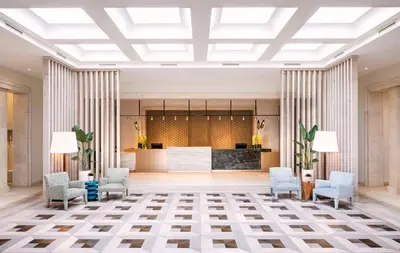 a lobby with chairs and a reception desk at Eurostars Sitges in Sitges