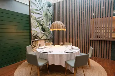 a dining room with a white table and chairs at Aparthotel Atenea Barcelona in Barcelona
