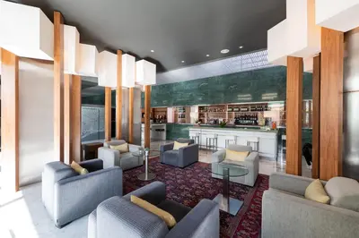 a lobby with a bar and chairs in a building at Aparthotel Atenea Barcelona in Barcelona