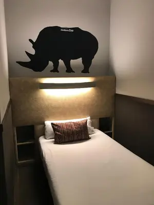 a bedroom with a bed with a bear on the wall at Chic & Basic Zoo in Barcelona