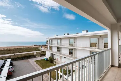 a balcony with a view of the ocean at Apartamentos Marfina in Castelldefels