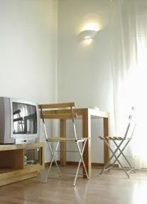 a living room with two chairs and a television at BCN2STAY Apartments in Barcelona