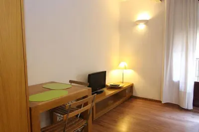 a small room with a desk with a computer on it at BCN2STAY Apartments in Barcelona