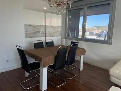a dining room with a table and chairs at Fira de Barcelona City View Apartment with Garage Parking in Hospitalet de Llobregat