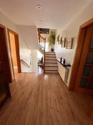 a hallway with wooden floors and stairs in a house at Sunny forest Villa near Barcelona in Vallirana