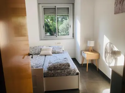 a small bedroom with a bed and a window at Standing Apartment Barcelona Forum in Sant Adria de Besos