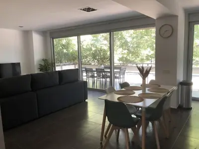 a living room with a couch and a table and chairs at Standing Apartment Barcelona Forum in Sant Adria de Besos