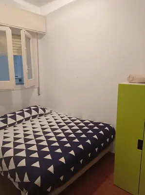 a bedroom with a black and white bed and a window at SWEET APARTMENT IN GRACIA DISTRICT! in Barcelona