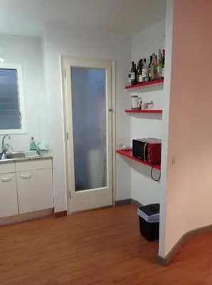 a kitchen with a sink and a door with a microwave at SWEET APARTMENT IN GRACIA DISTRICT! in Barcelona