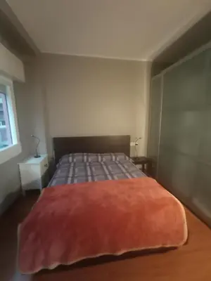 a bedroom with a bed with a red rug on it at SWEET APARTMENT IN GRACIA DISTRICT! in Barcelona