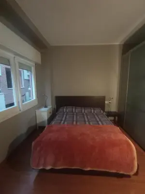 a bedroom with a bed with a red blanket on it at SWEET APARTMENT IN GRACIA DISTRICT! in Barcelona
