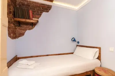 a bed in a room with a brick wall at Homenfun Barcelona Eixample I in Barcelona