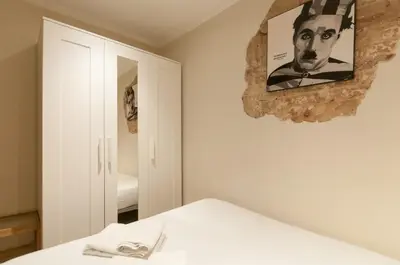 a bedroom with a bed and a picture on the wall at Homenfun Barcelona Eixample I in Barcelona