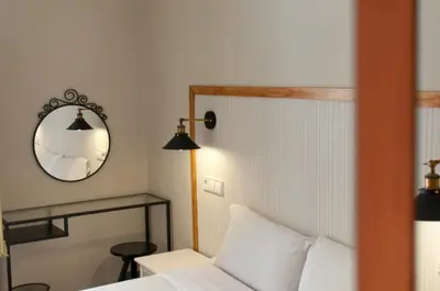 a bedroom with a white bed and a mirror at Homenfun Barcelona Eixample I in Barcelona