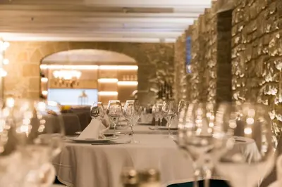 a table with wine glasses on it in a restaurant at Sant Jordi Boutique Hotel in Calella