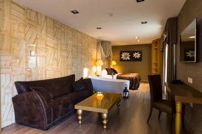 a living room with a couch and a bed at Sant Jordi Boutique Hotel in Calella