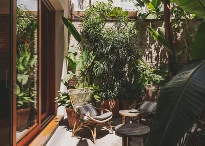 a patio with chairs and plants in a building at Hotel Regina Barcelona in Barcelona