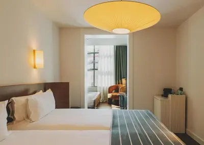 a bedroom with a large bed with a yellow ceiling at Hotel Regina Barcelona in Barcelona