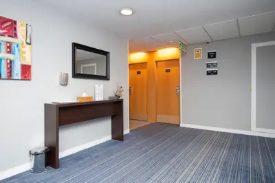 an office hallway with a desk and a mirror at Holiday Inn Express Barcelona - Montmeló by IHG in Granollers